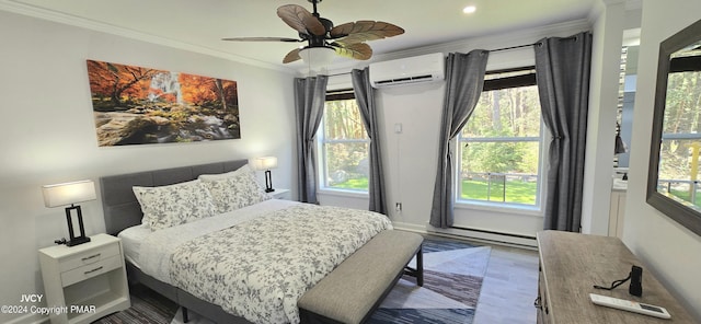 bedroom with crown molding, a baseboard heating unit, an AC wall unit, wood finished floors, and baseboards