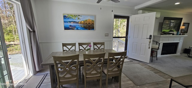 dining space featuring ceiling fan, a fireplace, crown molding, and recessed lighting