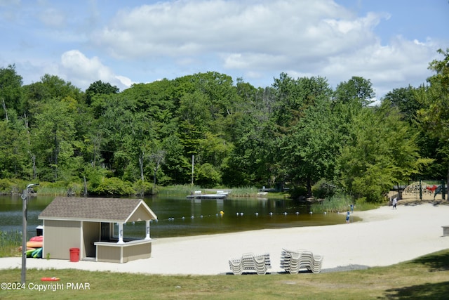 view of community featuring a water view and a wooded view