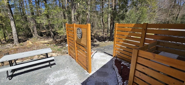 view of gate featuring a view of trees