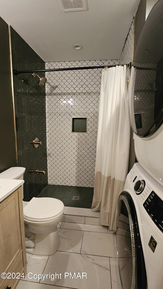 104 Haverhill Rd, Buck Hill Falls, PA 18323 - full bath with estacked washer and dryer, a tile shower, marble look tiles, and vanity
