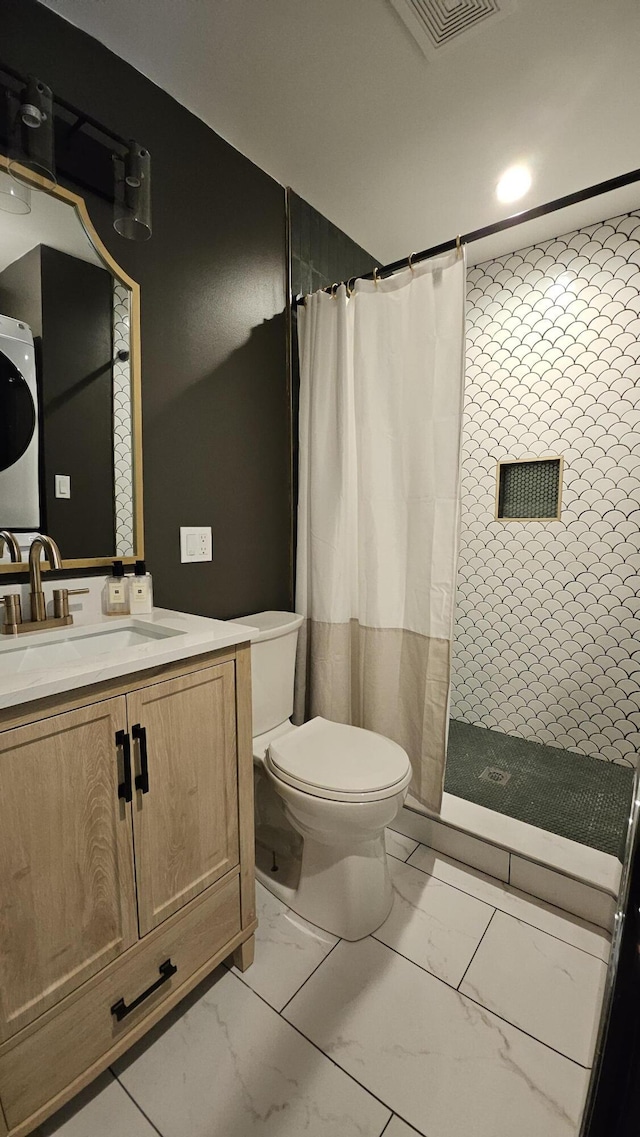 104 Haverhill Rd, Buck Hill Falls, PA 18323 - bathroom featuring marble look tile flooring, tiled shower, vanity, and stacked washing machine and dryer
