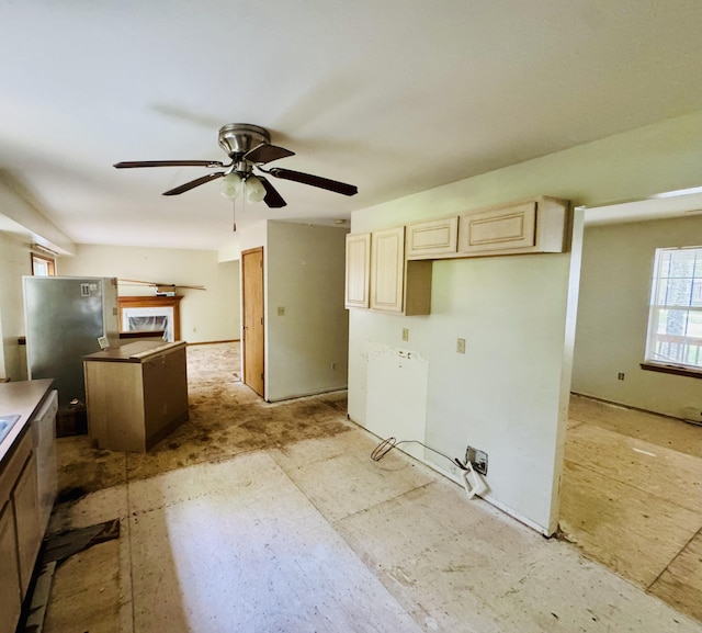 2149 Valley View Dr, Bushkill, PA 18324 - kitchen featuring ceiling fan, freestanding refrigerator, cream cabinetry, and a fireplace