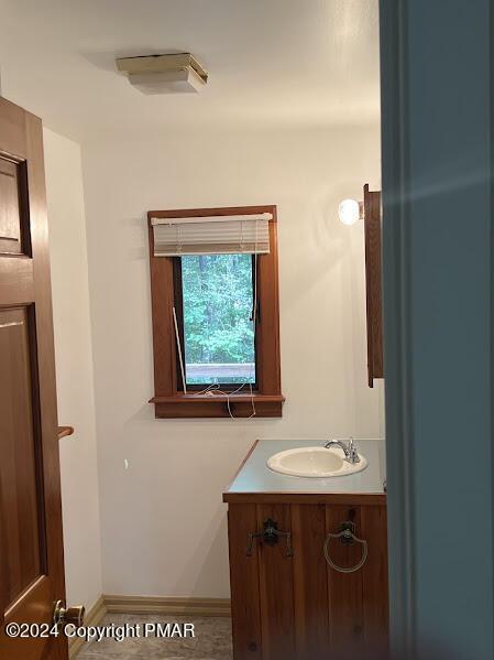 bathroom with vanity and baseboards