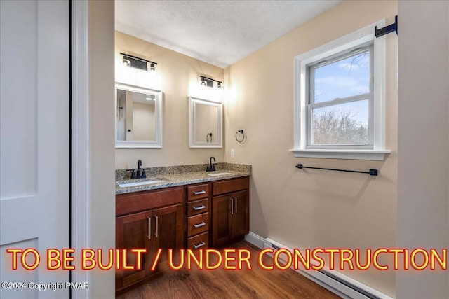 84 Parker Trl, Albrightsville, PA 18210 - bathroom featuring double vanity, a textured ceiling, a sink, and wood finished floors