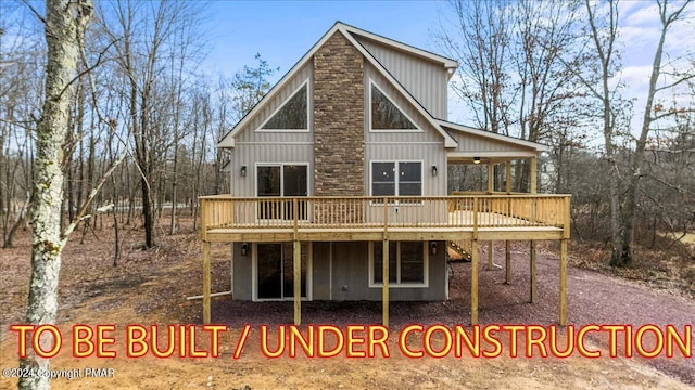 rear view of property with a deck and board and batten siding