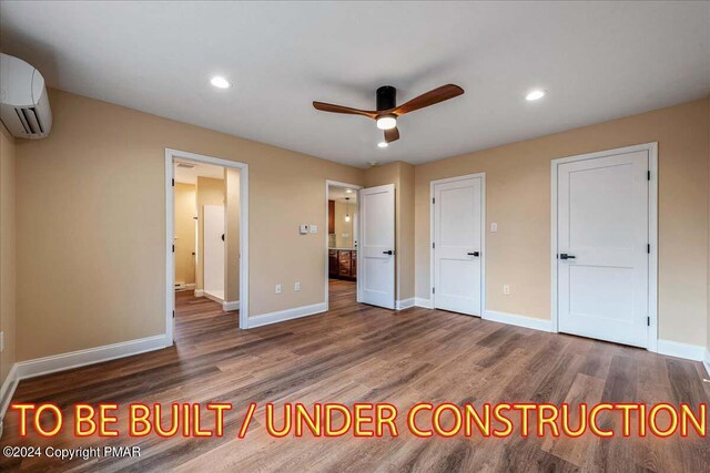 84 Parker Trl, Albrightsville, PA 18210 - unfurnished bedroom with baseboards, wood finished floors, and a wall mounted air conditioner