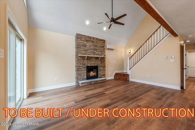 84 Parker Trl, Albrightsville, PA 18210 - unfurnished living room with a wall mounted air conditioner, baseboards, stairs, ceiling fan, and wood finished floors