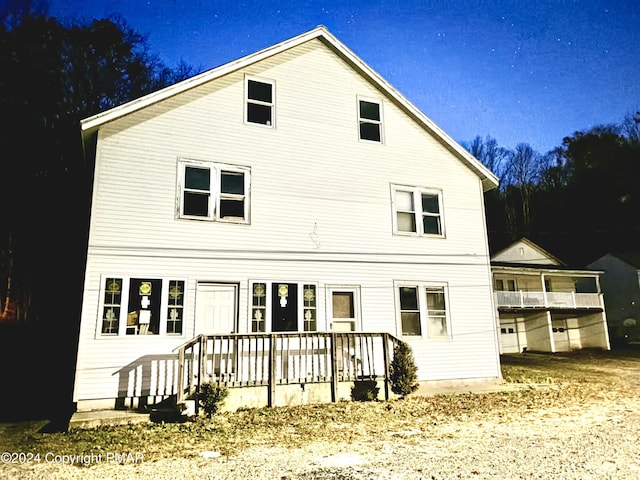 back of property featuring a wooden deck