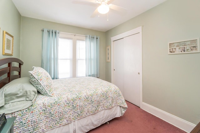 carpeted bedroom featuring a closet, baseboards, and a ceiling fan