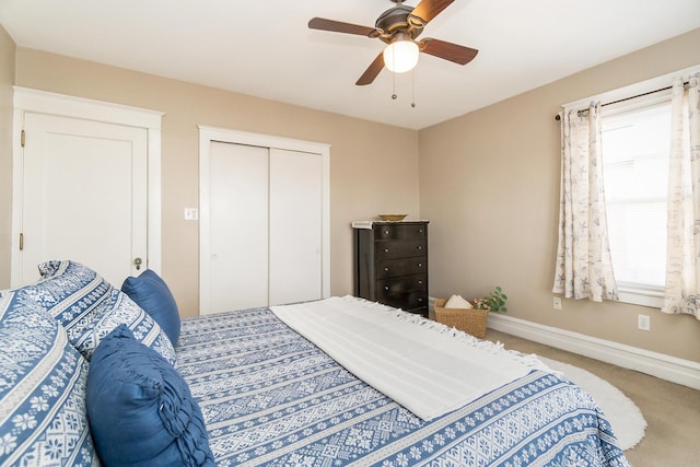 carpeted bedroom featuring baseboards, a closet, and ceiling fan