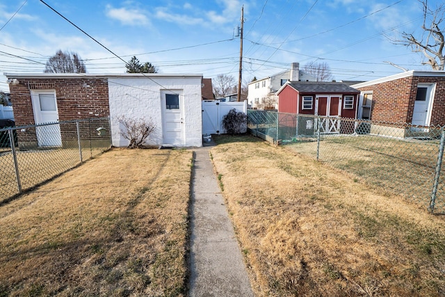 view of yard with an outbuilding and a fenced backyard