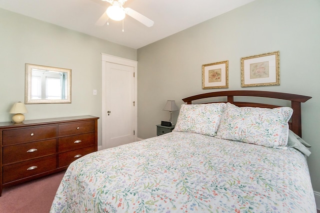 bedroom with a ceiling fan and dark carpet