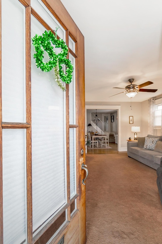 interior space featuring ceiling fan and carpet