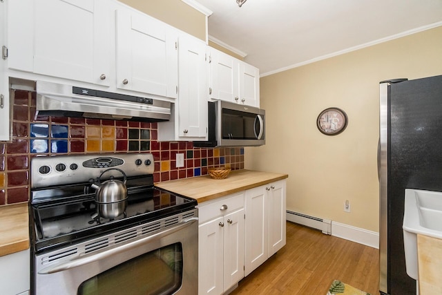 kitchen featuring a baseboard radiator, ornamental molding, decorative backsplash, appliances with stainless steel finishes, and under cabinet range hood