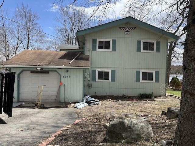 6069 Boardwalk Dr, Tobyhanna, PA 18466 - rear view of house featuring a garage, driveway, and a shingled roof