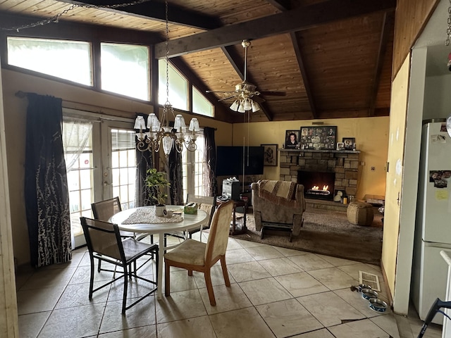 6069 Boardwalk Dr, Tobyhanna, PA 18466 - dining space featuring wooden ceiling with exposed beams, a fireplace, a ceiling fan, light tile patterned floors, and a chandelier