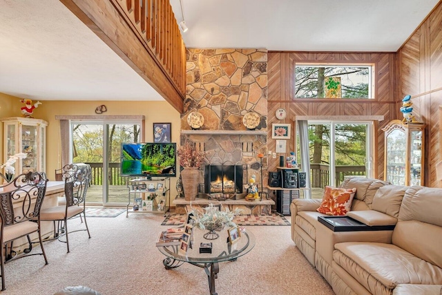 176 Manchester Dr, Bushkill, PA 18324 - carpeted living room with wooden walls and a fireplace