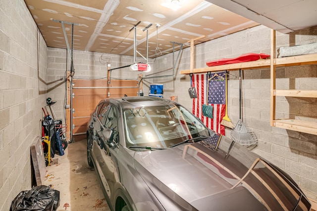 176 Manchester Dr, Bushkill, PA 18324 - garage featuring a garage door opener and concrete block wall