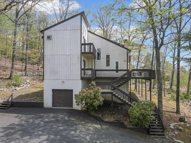 176 Manchester Dr, Bushkill, PA 18324 - view of home's exterior with stairs, an attached garage, a balcony, and a wooden deck