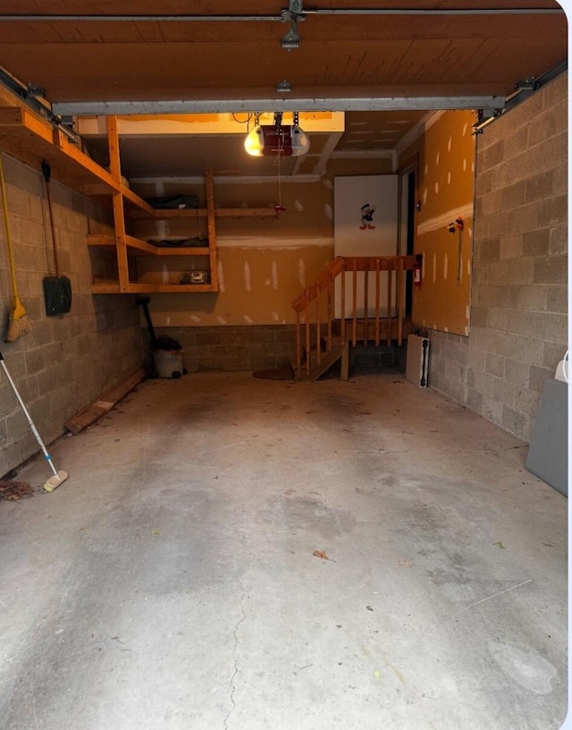 176 Manchester Dr, Bushkill, PA 18324 - garage featuring a garage door opener and concrete block wall