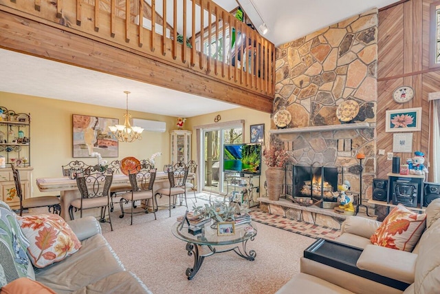 176 Manchester Dr, Bushkill, PA 18324 - carpeted living area featuring a chandelier, a wall unit AC, a towering ceiling, and a stone fireplace
