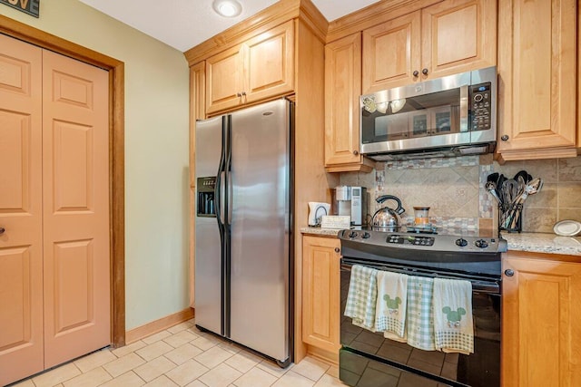 176 Manchester Dr, Bushkill, PA 18324 - kitchen featuring stainless steel appliances, backsplash, light brown cabinetry, light stone countertops, and light tile patterned flooring