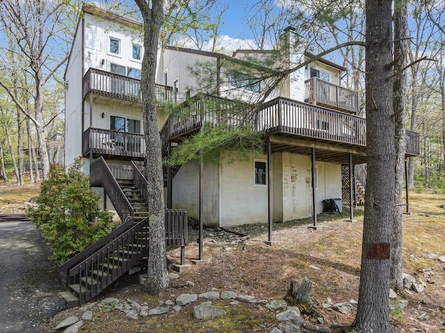 176 Manchester Dr, Bushkill, PA 18324 - rear view of property featuring stairway, a wooden deck, and a balcony