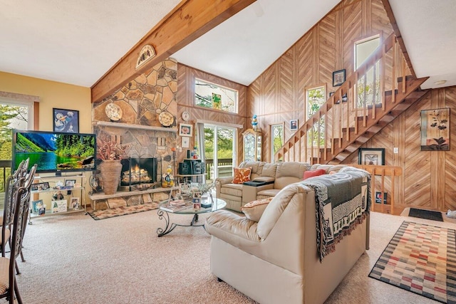 176 Manchester Dr, Bushkill, PA 18324 - living room with stairs, carpet, a fireplace, wooden walls, and beamed ceiling
