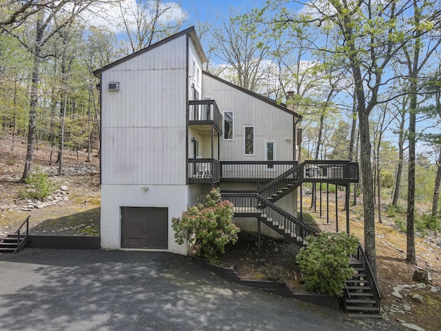 176 Manchester Dr, Bushkill, PA 18324 - view of property exterior featuring stairs, a garage, a balcony, and a wooden deck