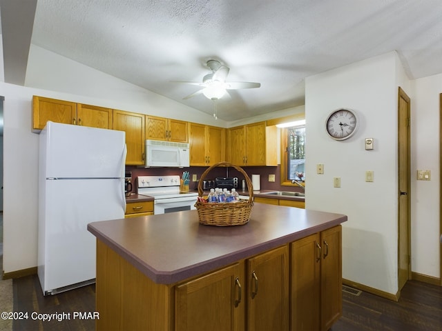 5310 Conoquenissing Dr, Pocono Lake, PA 18347 - kitchen with brown cabinets, lofted ceiling, dark countertops, a sink, and white appliances