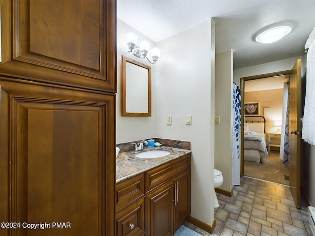 5310 Conoquenissing Dr, Pocono Lake, PA 18347 - bathroom with a baseboard radiator, toilet, stone finish floor, vanity, and baseboards