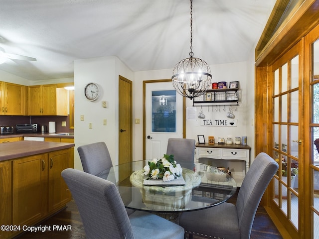5310 Conoquenissing Dr, Pocono Lake, PA 18347 - dining room featuring ceiling fan with notable chandelier, dark wood-style floors, and a toaster