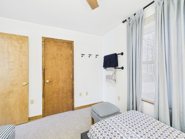 bedroom featuring baseboards, ceiling fan, and carpet flooring