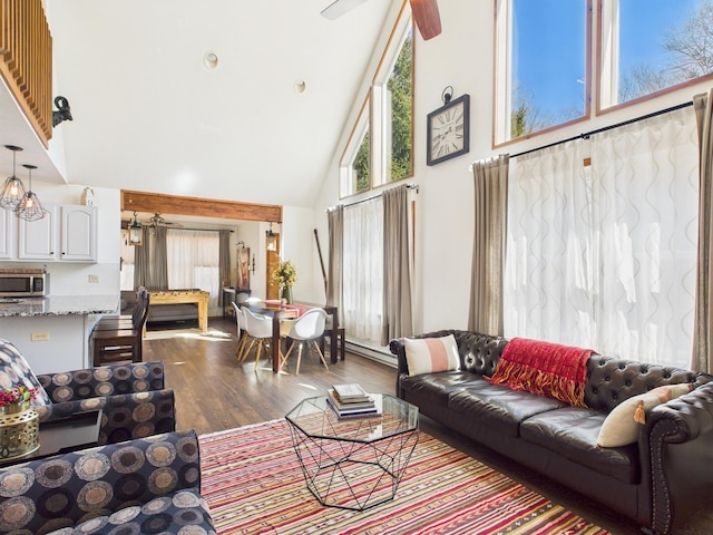 living area featuring ceiling fan, dark wood-style floors, and high vaulted ceiling