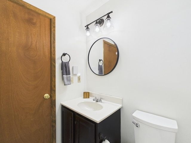 bathroom with toilet and vanity