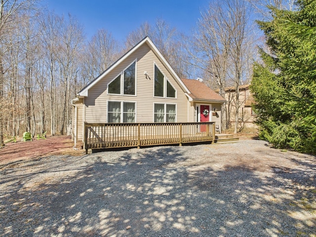 rear view of property featuring a deck