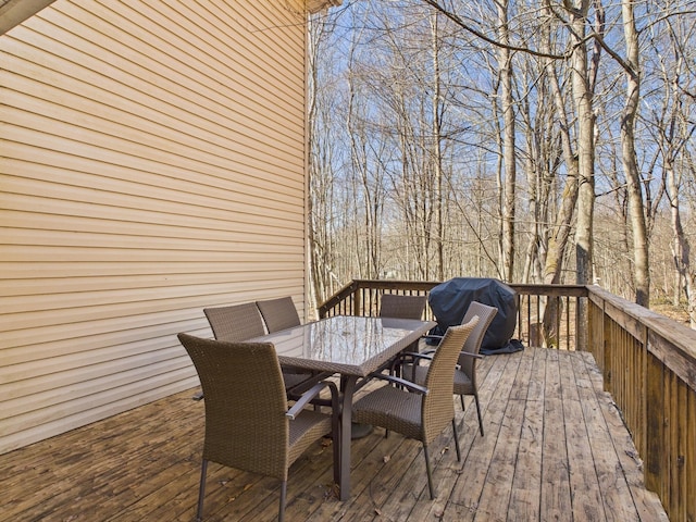 deck featuring a grill and outdoor dining area