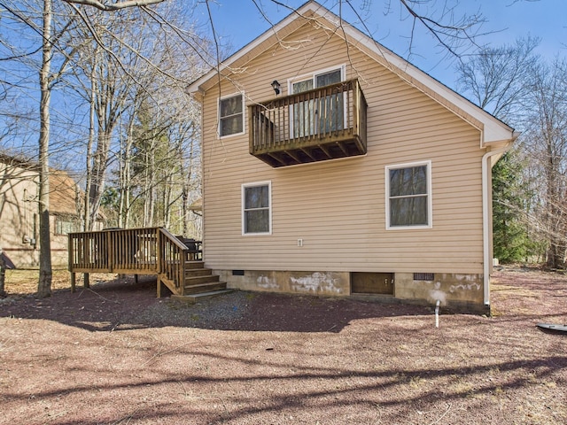 back of house with a deck and crawl space