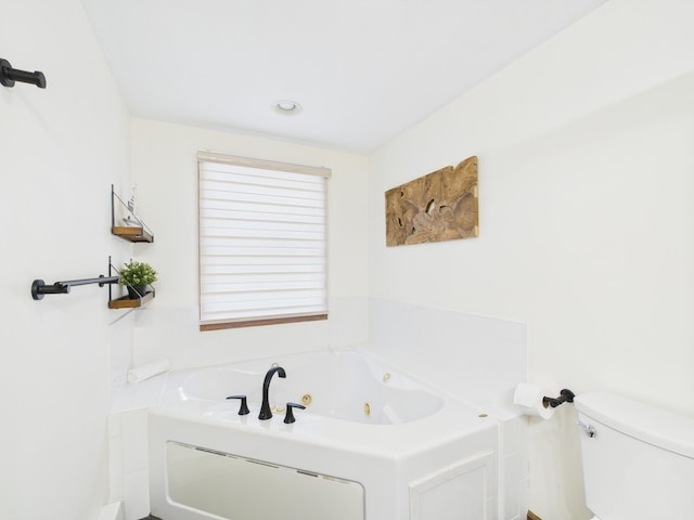 full bathroom featuring toilet and a tub with jets