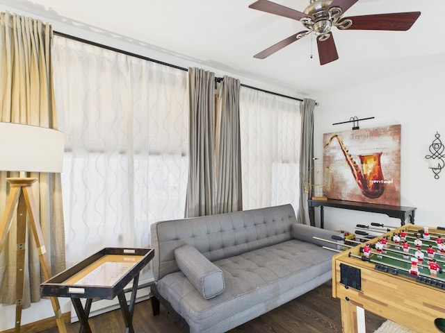 living room with wood finished floors and ceiling fan