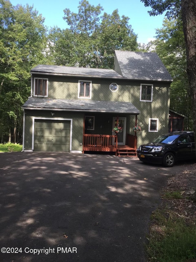 view of front of house featuring aphalt driveway and a garage