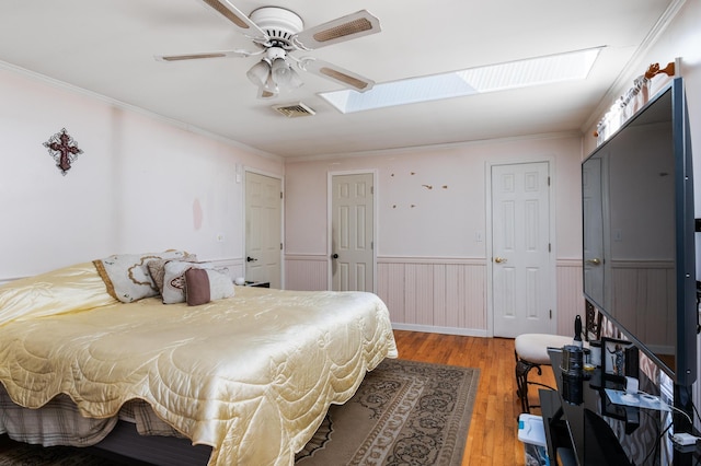 109 Little Doe Ln, East Stroudsburg, PA 18301 - bedroom with a skylight, wainscoting, light wood-type flooring, ornamental molding, and a ceiling fan