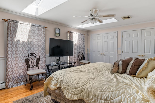 109 Little Doe Ln, East Stroudsburg, PA 18301 - bedroom featuring a skylight, multiple closets, wood finished floors, crown molding, and a wainscoted wall