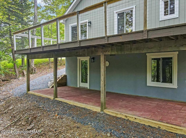 back of house featuring board and batten siding and a deck