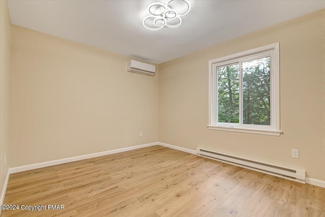 empty room with light wood-type flooring, baseboards, a wall mounted air conditioner, and baseboard heating