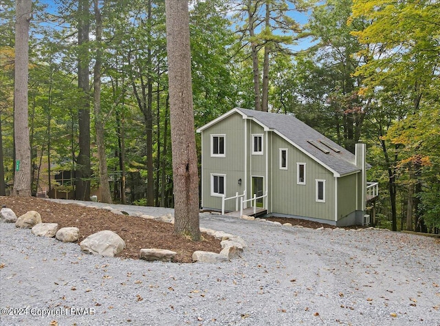 view of front of home with a shingled roof