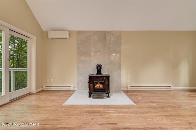 unfurnished living room with wood finished floors, a baseboard radiator, a wall unit AC, and a wood stove