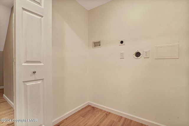 laundry area featuring hookup for a washing machine, laundry area, baseboards, light wood-style floors, and electric dryer hookup