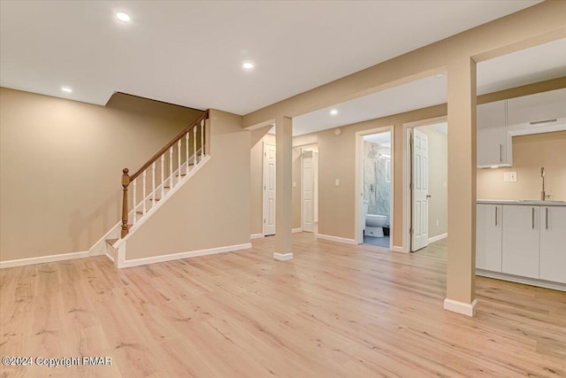 interior space with recessed lighting, a sink, baseboards, stairway, and light wood-type flooring